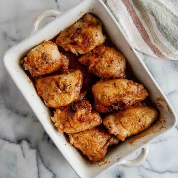 honey sriracha chicken thighs in baking dish.