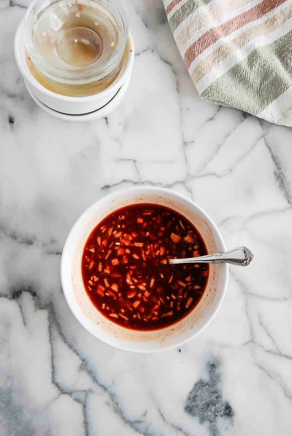 honey sriracha sauce in bowl with spoon.