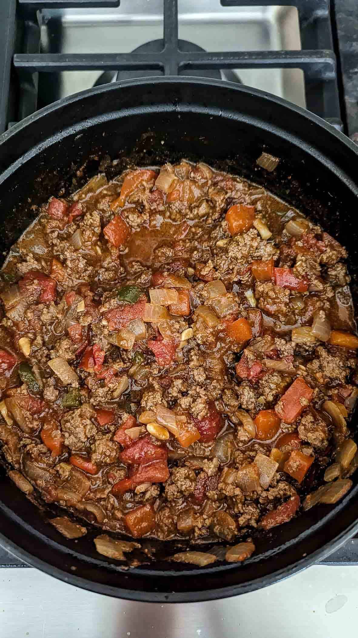 sloppy joes cooking in dutch oven on stovetop.