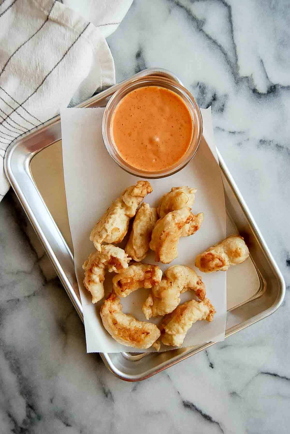 tempura shrimp on tray with dipping sauce to the side