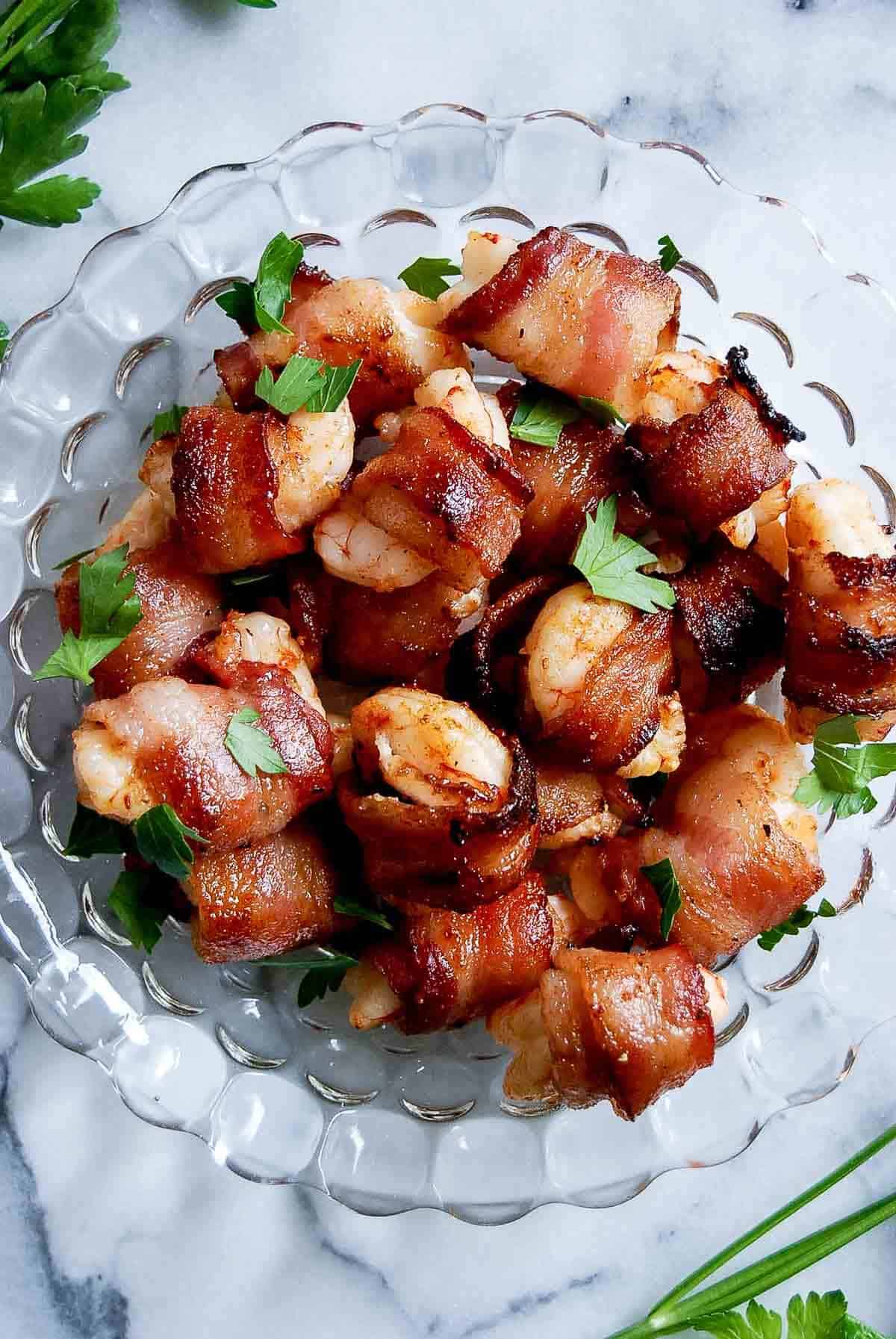 closeup of air fryer bacon wrapped shrimp.