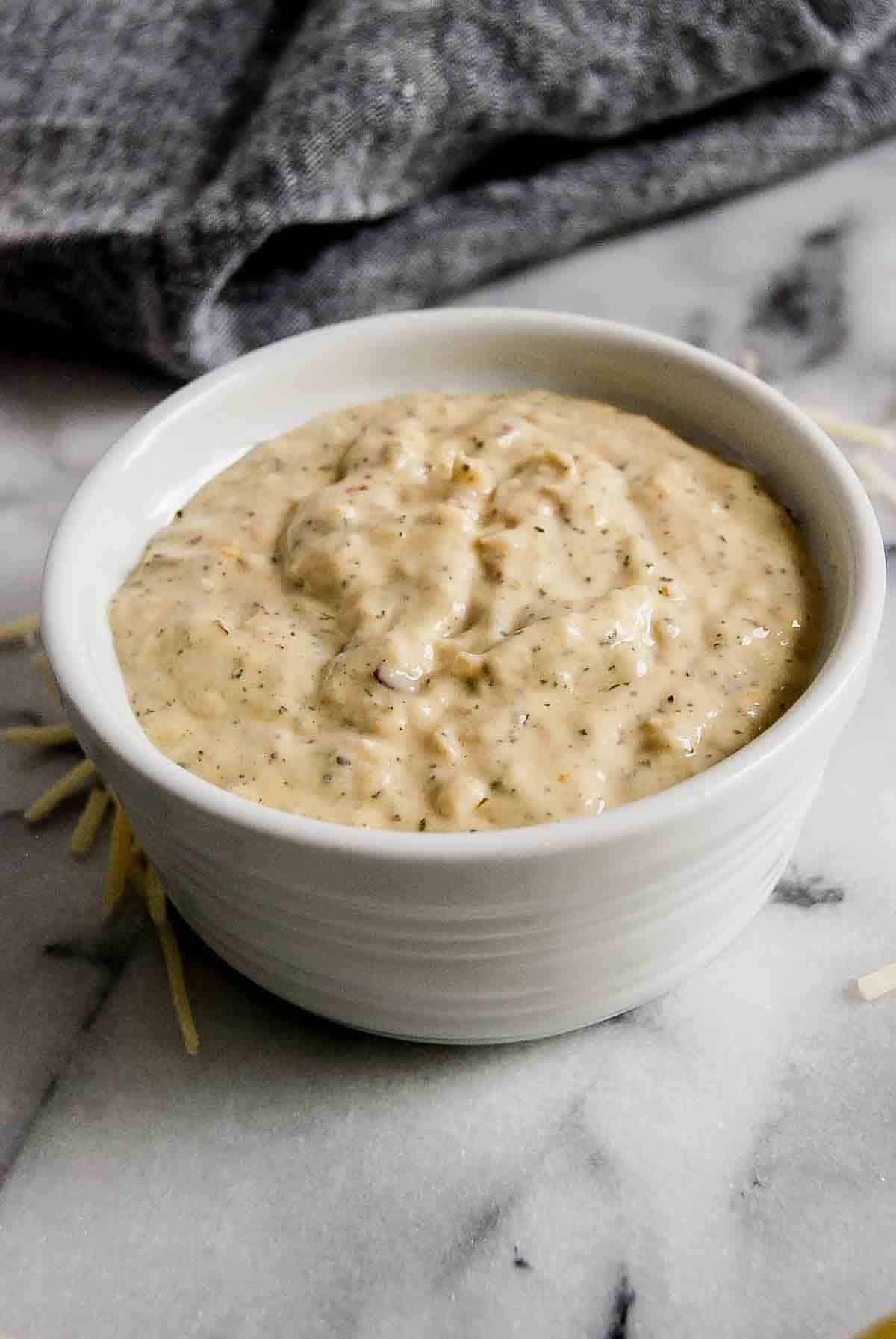 side view of parmesan garlic sauce on countertop.