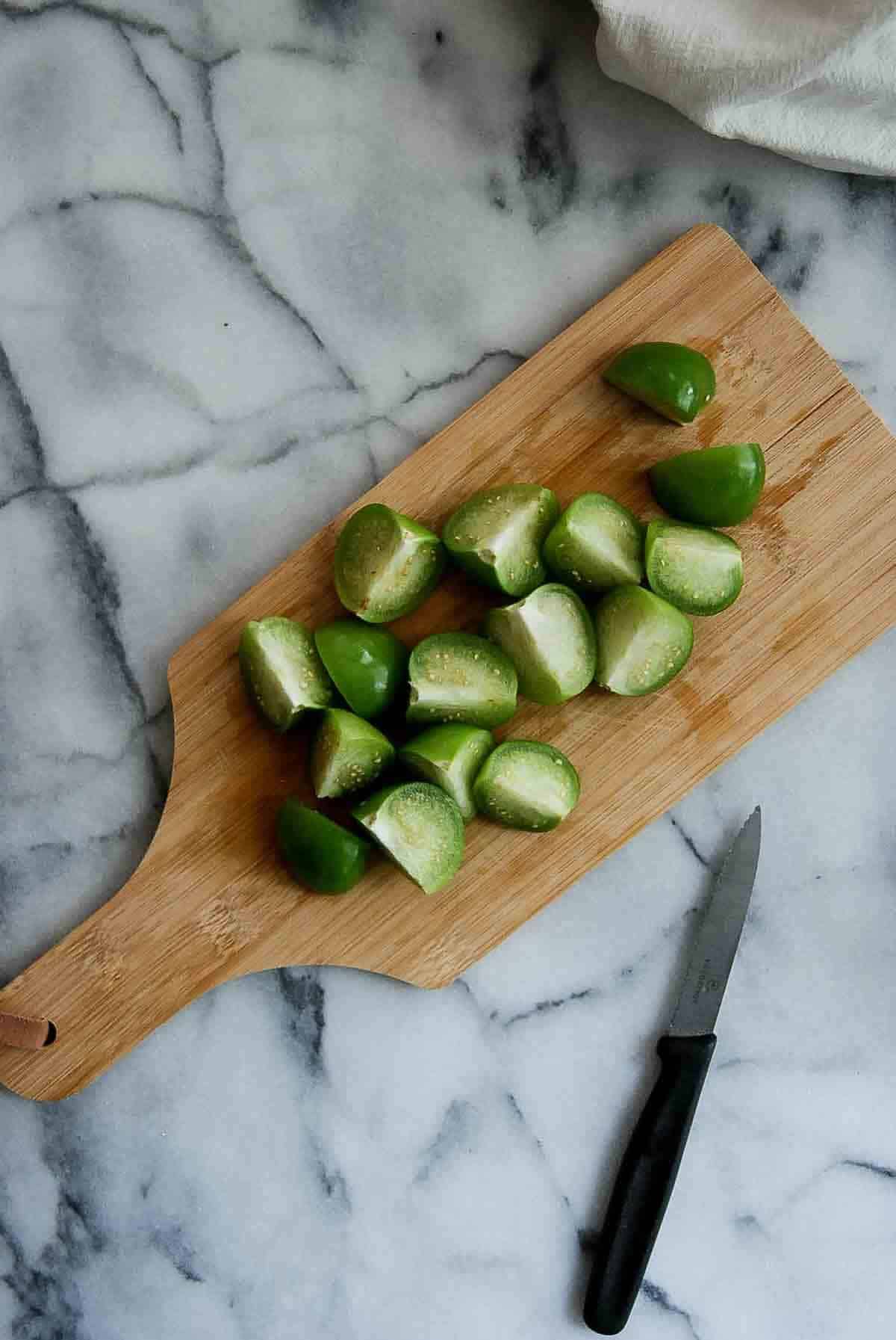 chopped tomatillos on cutting board.