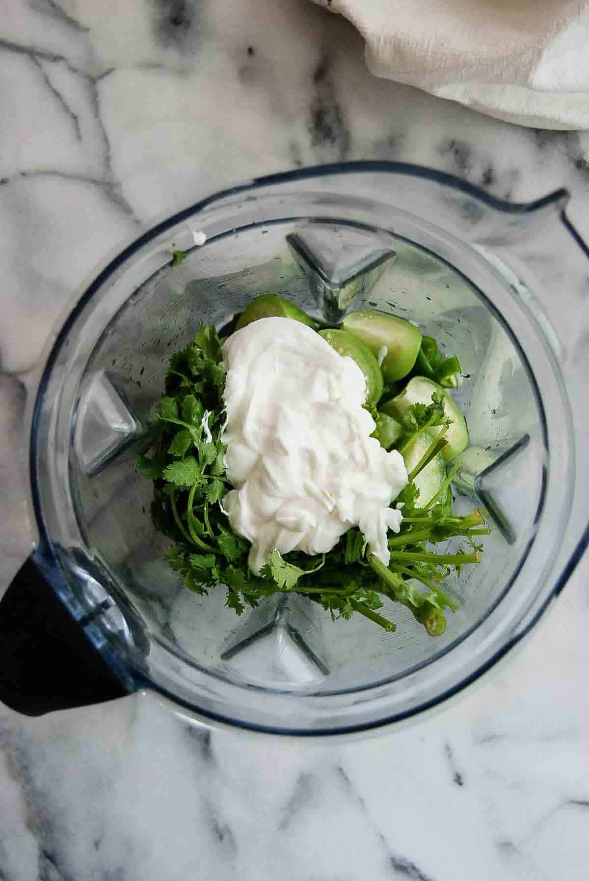 chopped peppers, garlic, tomatillos sour cream, and cilantro in blender.