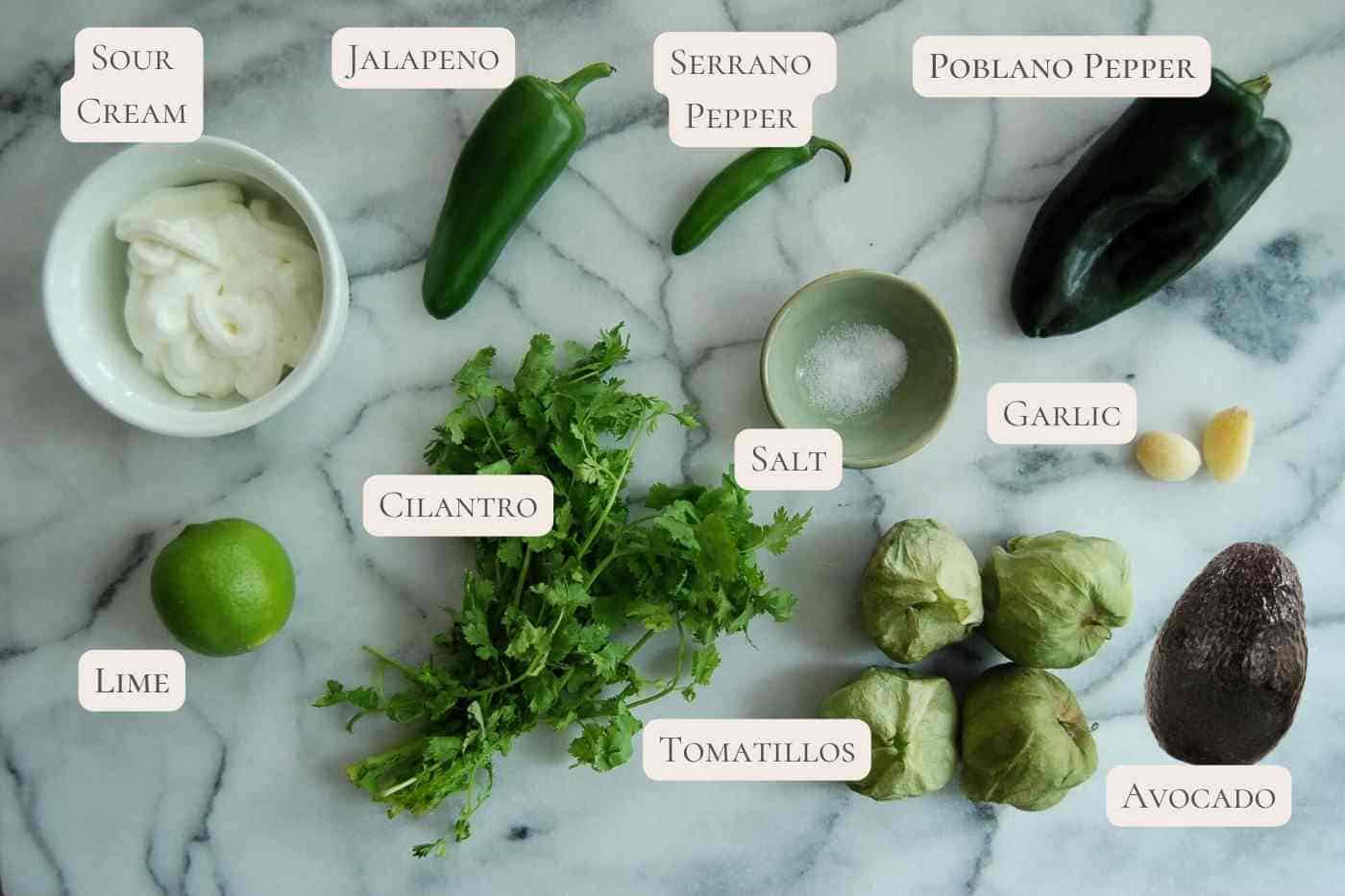 ingredients for green taco sauce on countertop, labeled.