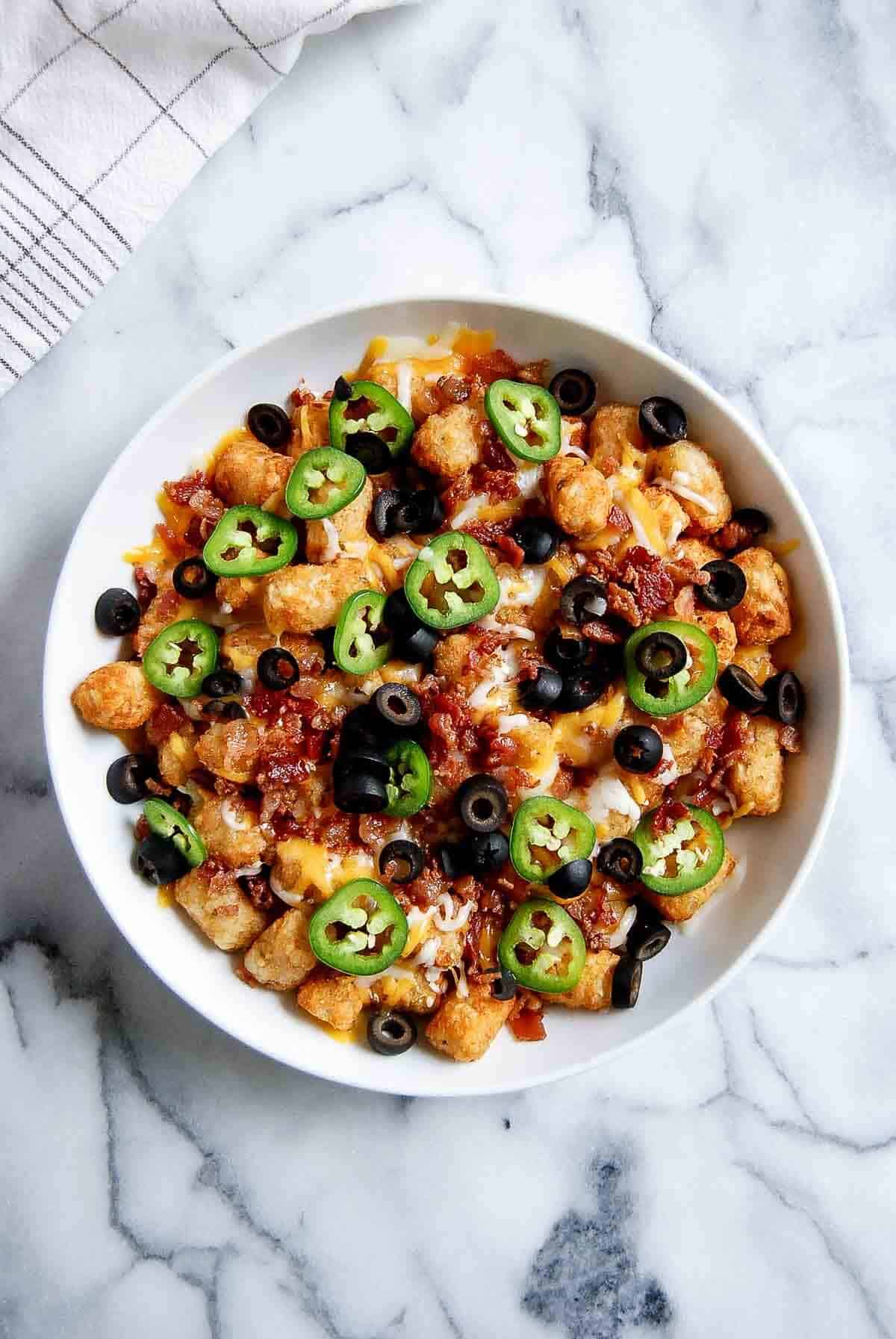 loaded tater tots with cheese, bacon, olives and jalapeno peppers.