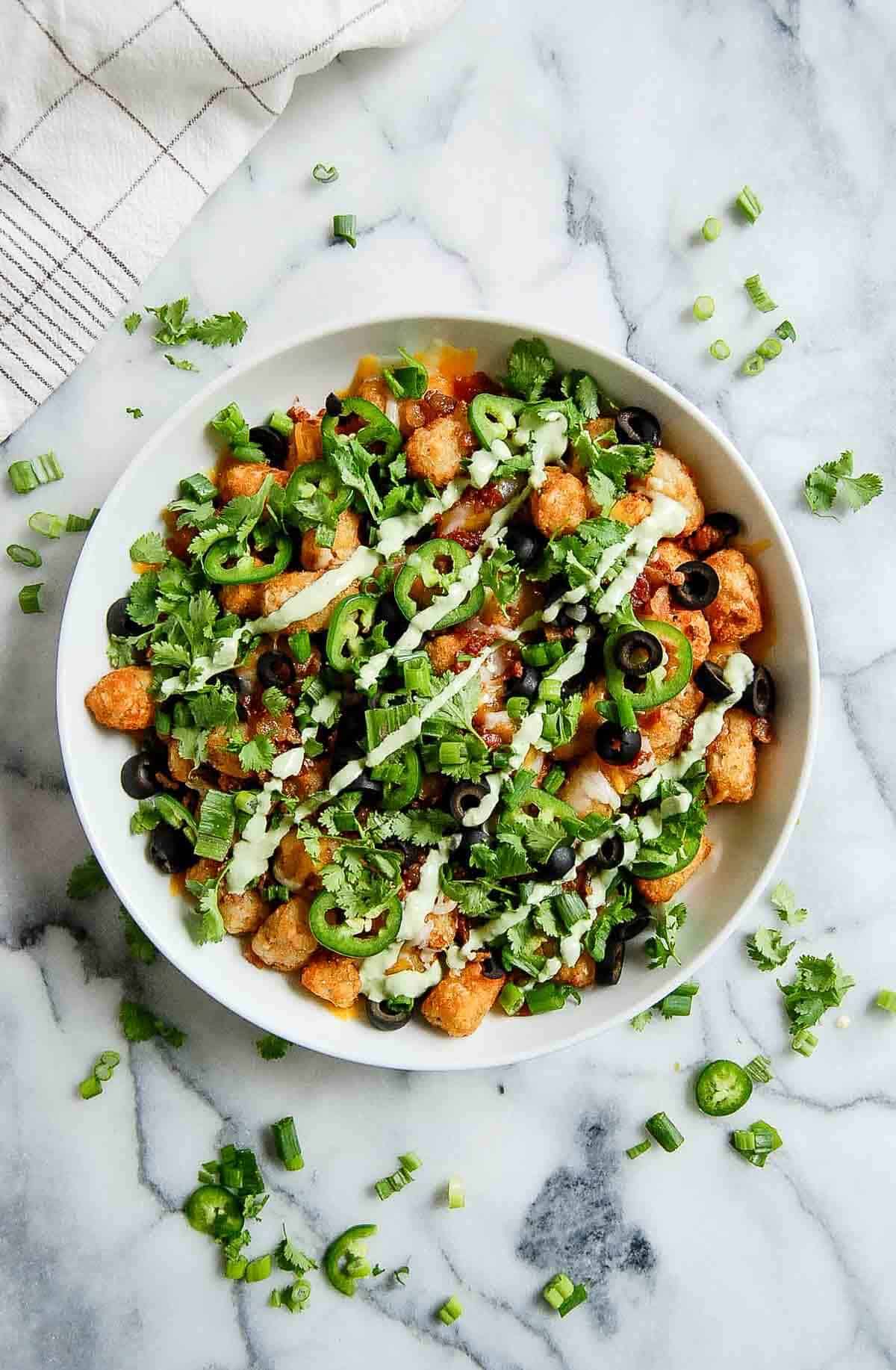 loaded tater tots in bowl on countertop.