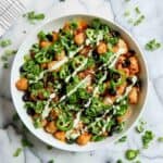 loaded tater tots in bowl on countertop.