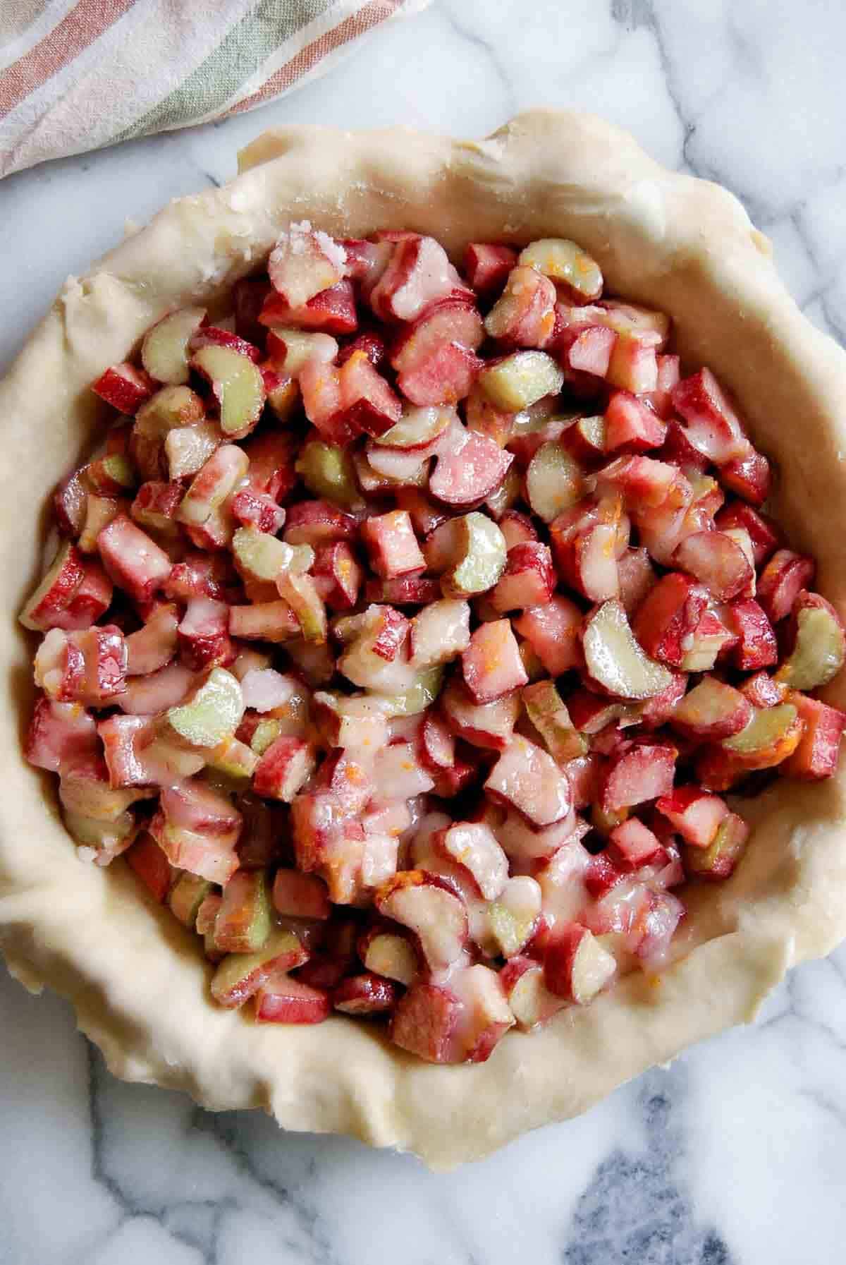 rolled out pie dough with chopped rhubarb-sugar mixture inside.