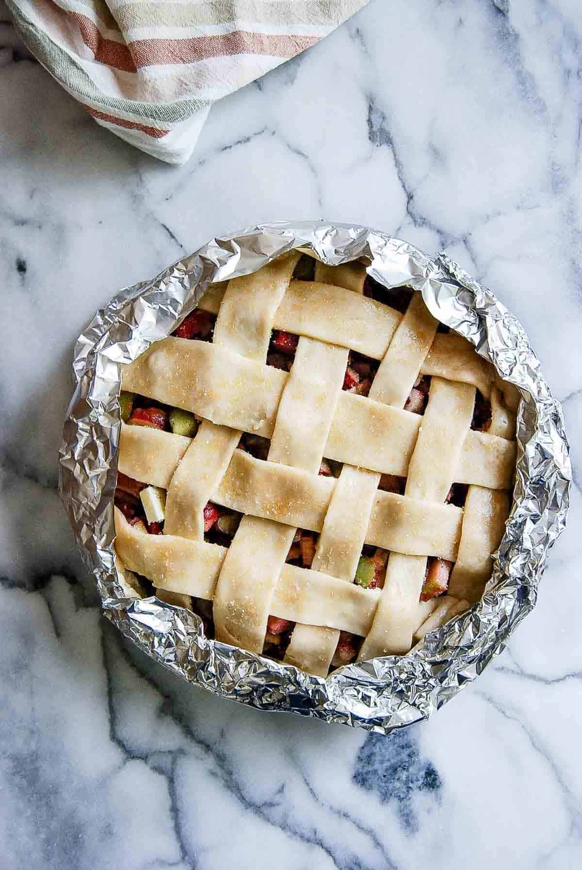 rhubarb pie, pre-baked, with foil pie crust shield.