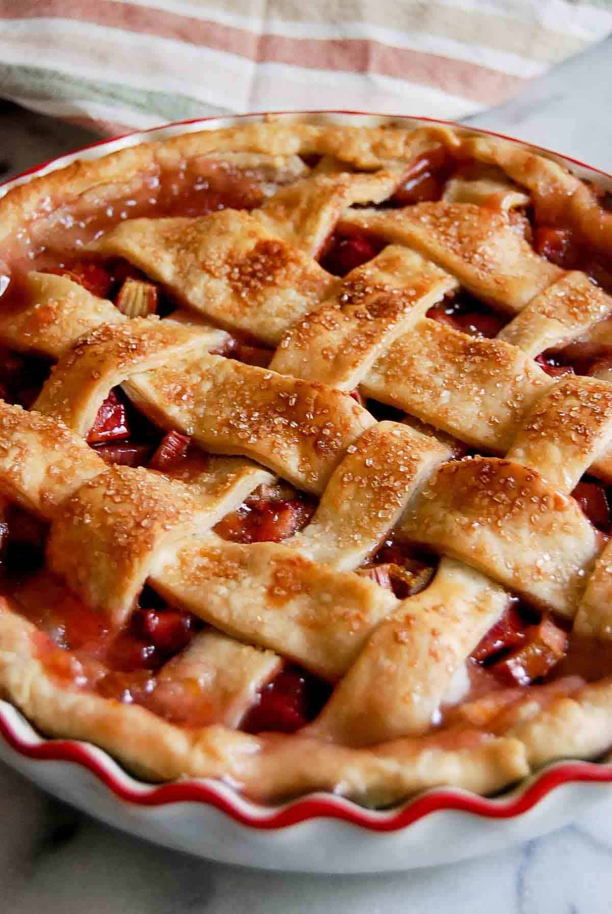 side view of rhubarb pie with lattice crust.