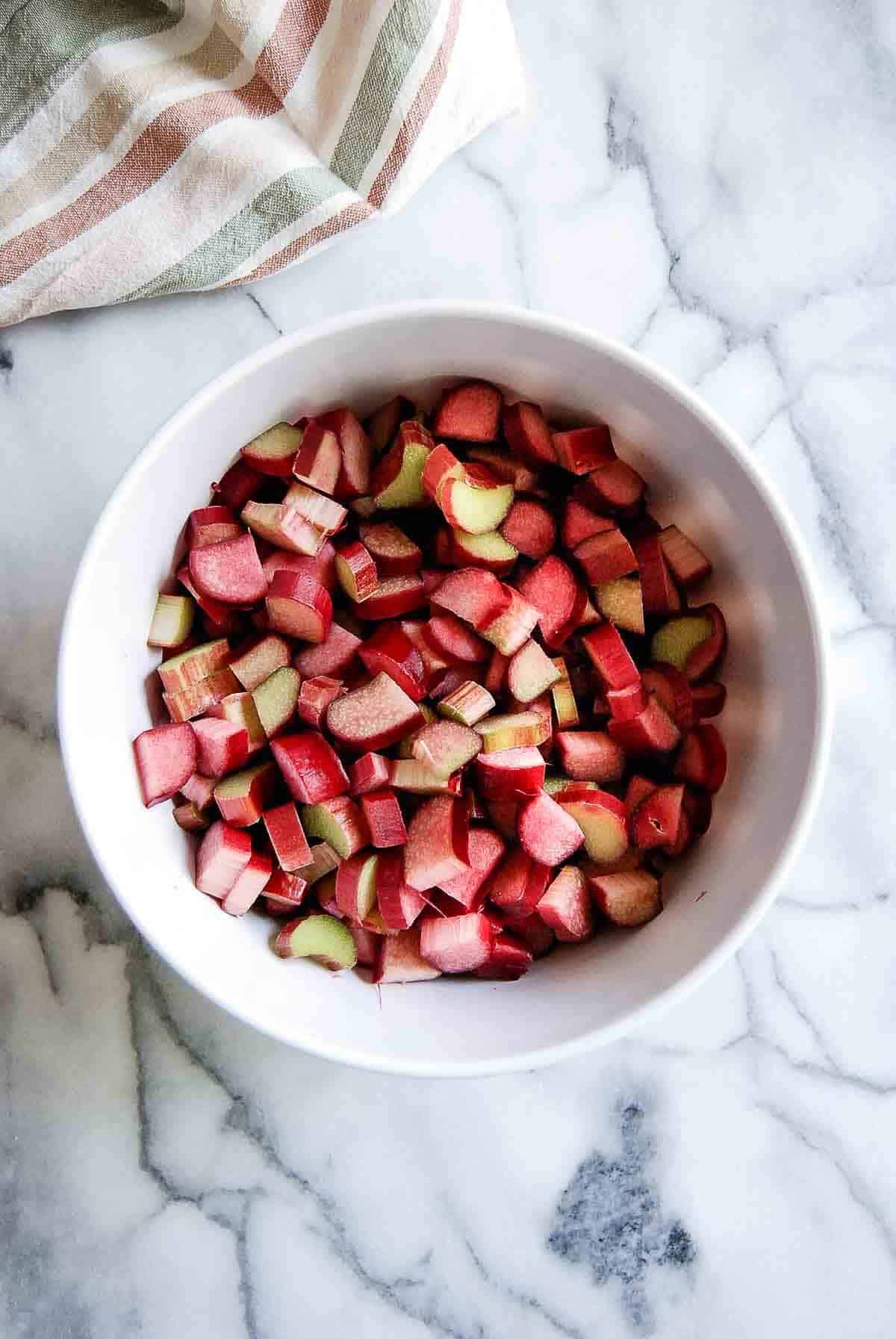 chopped fresh rhubarb in bowl on countertop.
