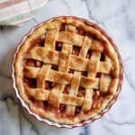rhubarb pie with lattice crust on countertop.