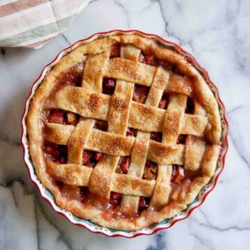 rhubarb pie with lattice crust on countertop.