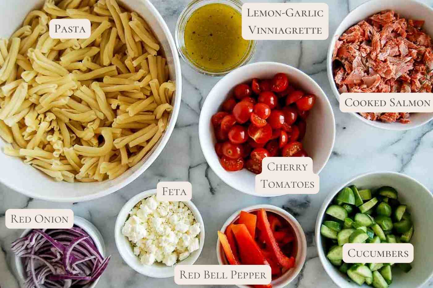 ingredients for salmon pasta salad on countertop, labeled.