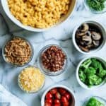 mac and cheese bar with toppings on countertop.