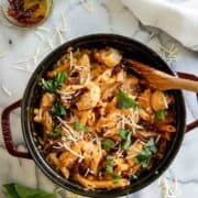 marry me chicken pasta in pot with wooden spoon.