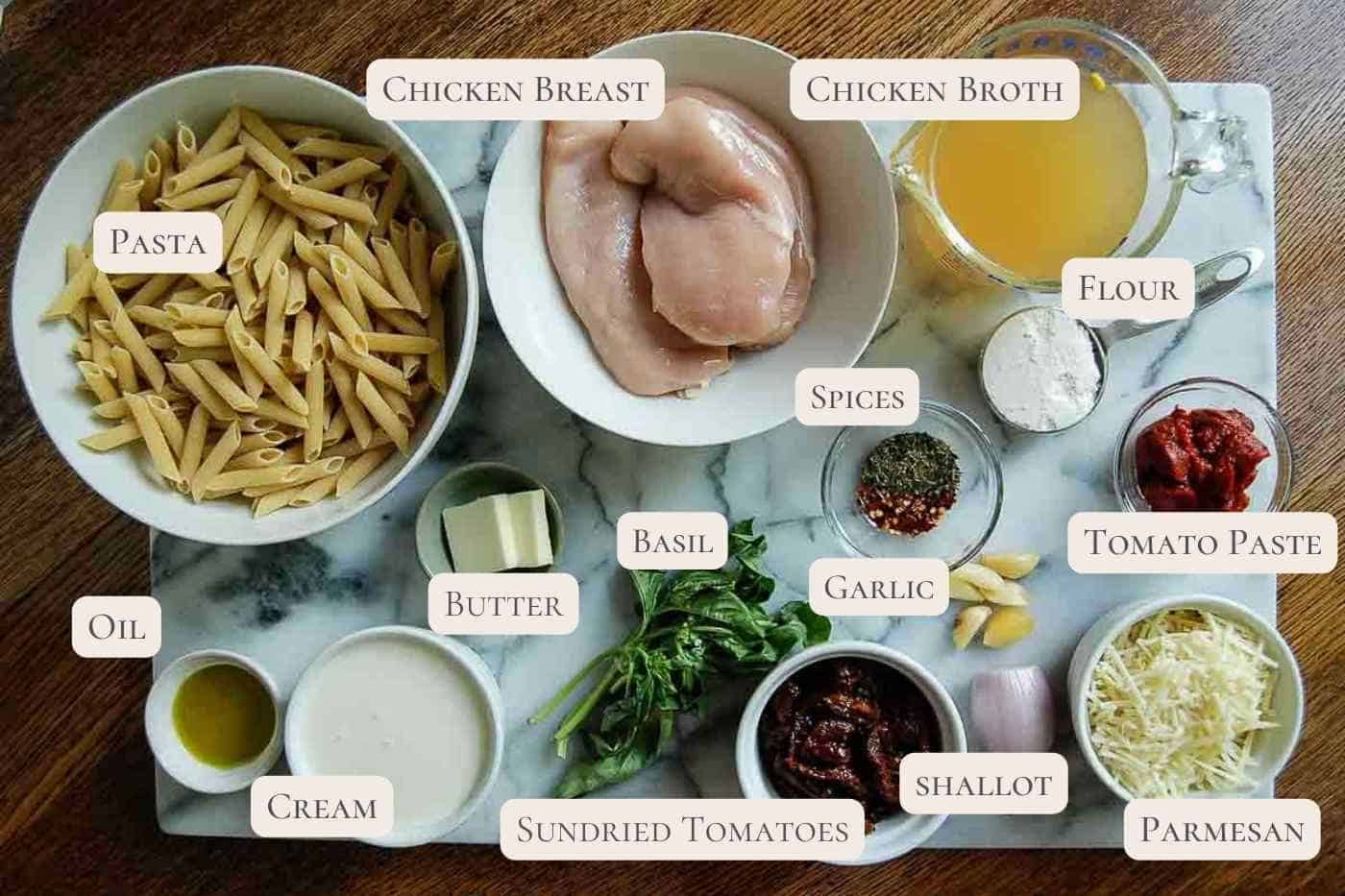 ingredients for marry me chicken pasta on cutting board.
