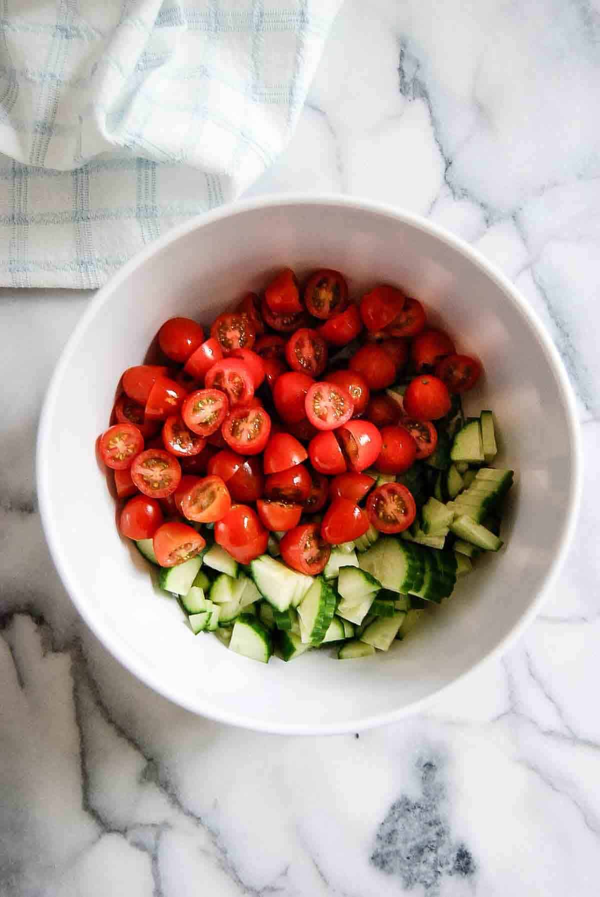 tomatoes and cucumber in bowl.