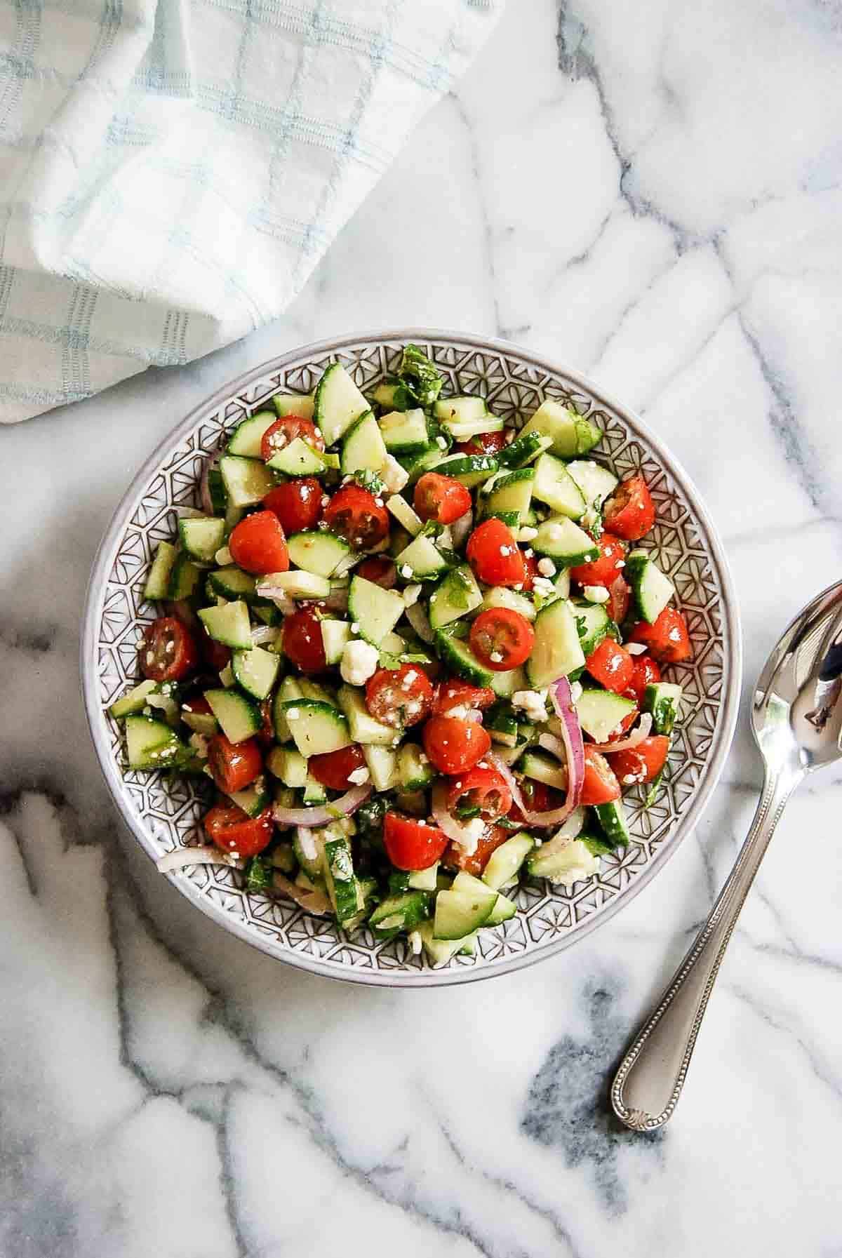 Mediterranean cucumber and tomato salad in serving bowl.