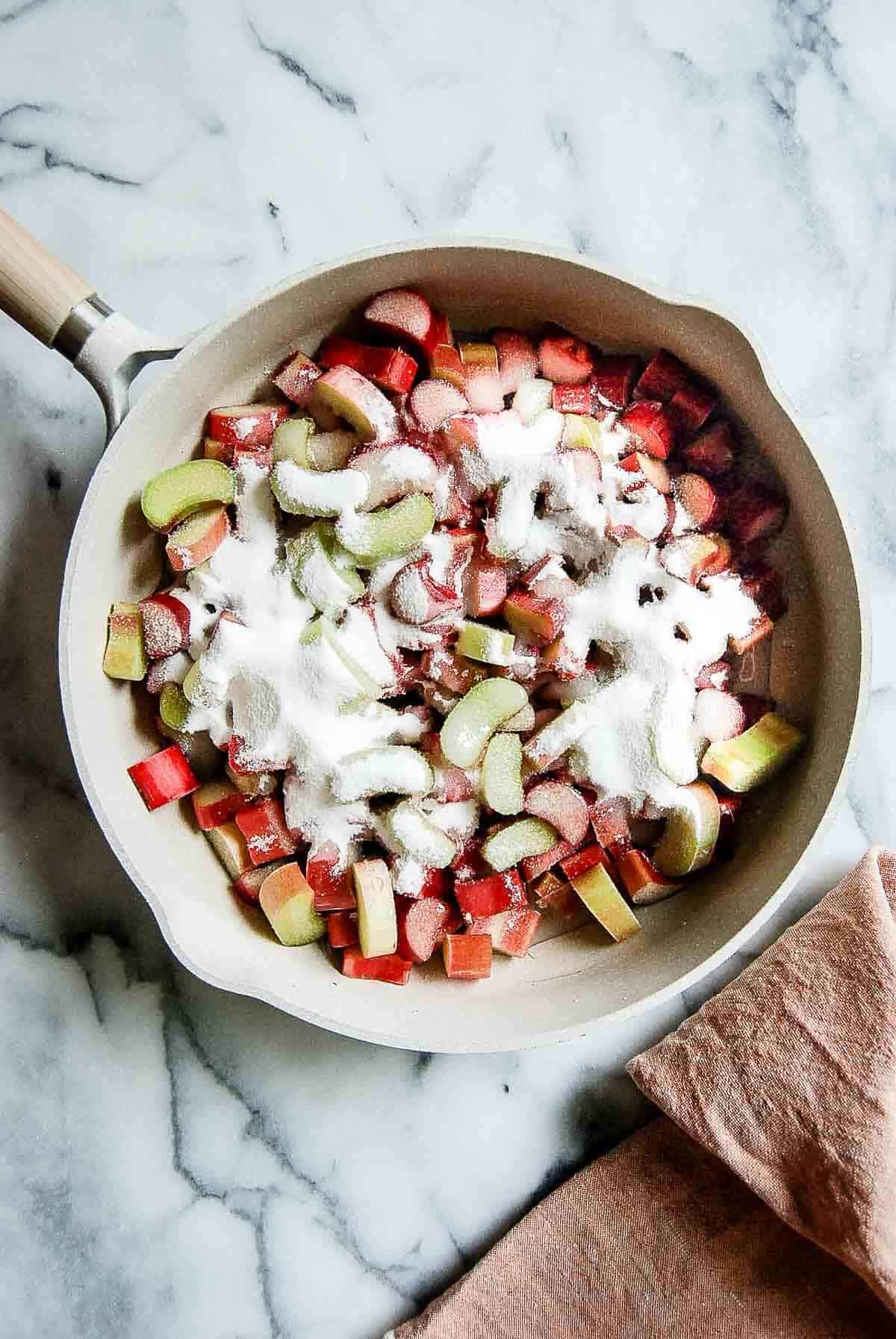 chopped rhubarb in saucepan mixed with water and sugar.