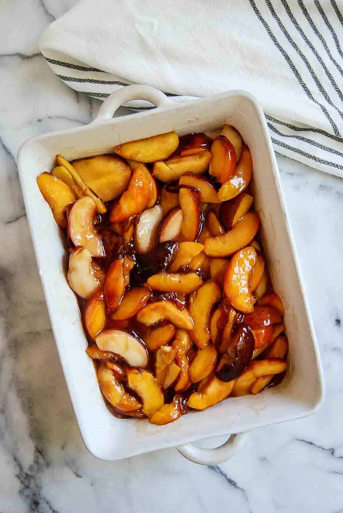 syrupy peaches in base of casserole dish.