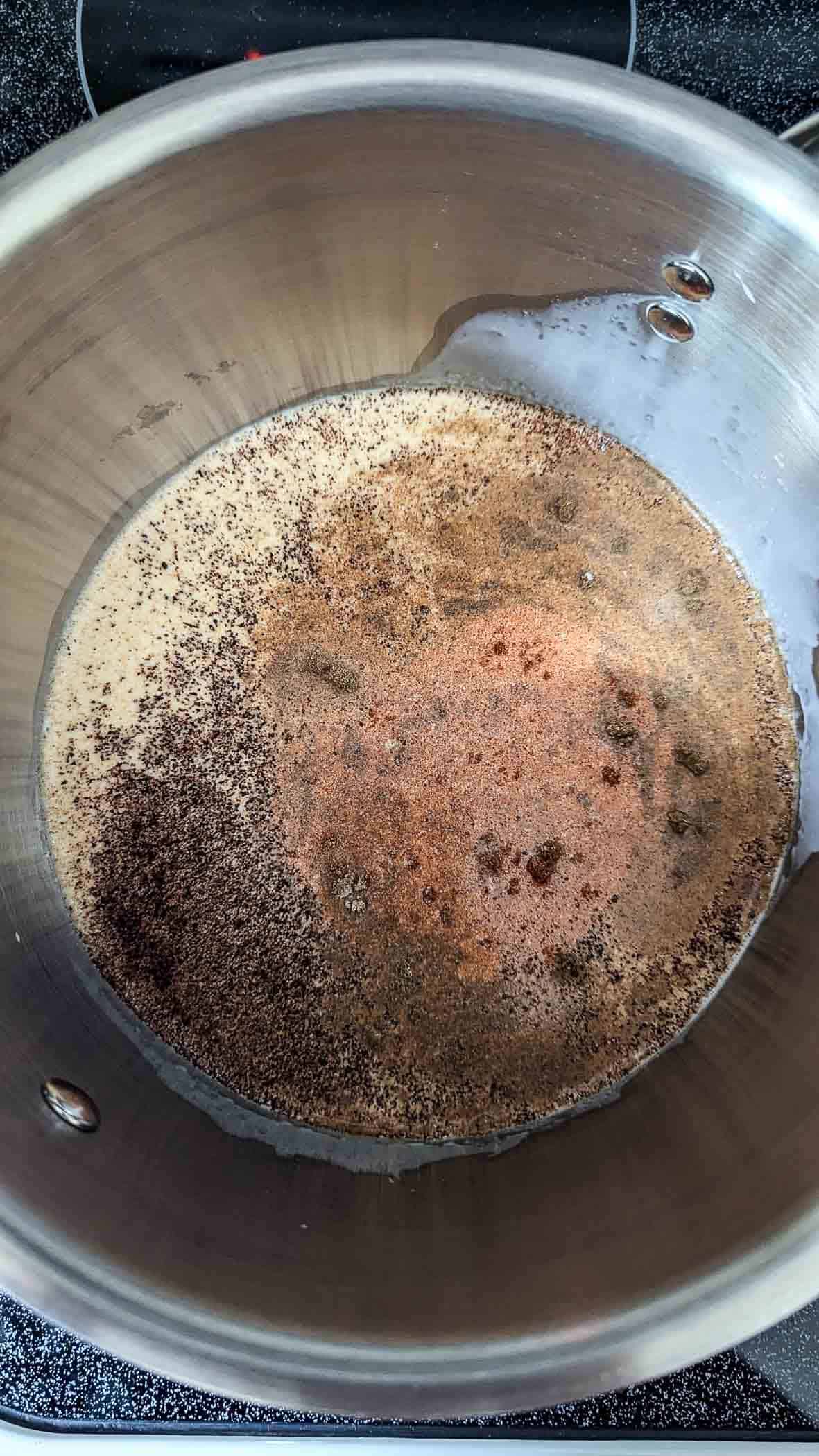 half n half and queso spices in saucepan.