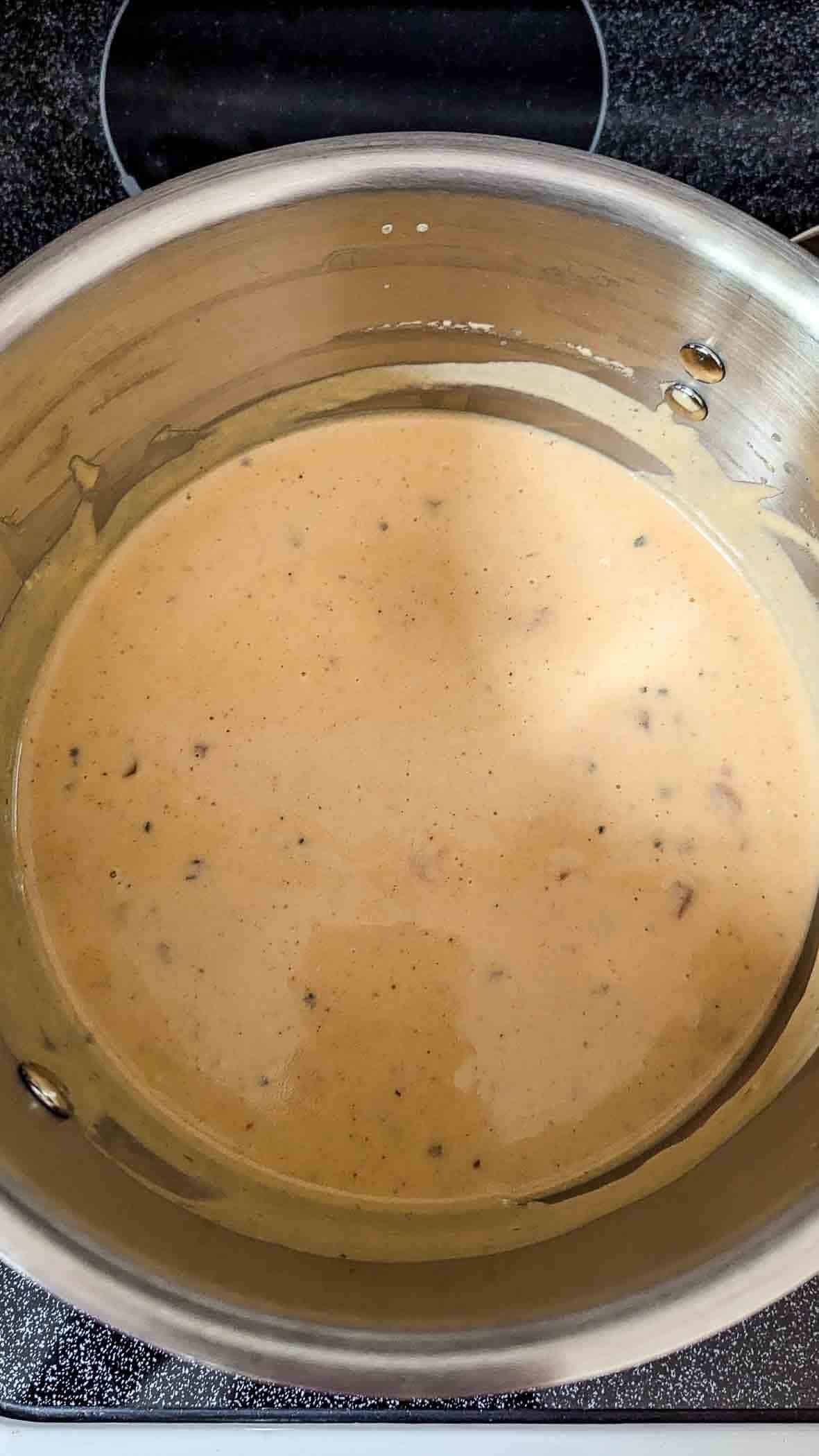 queso dip with melted cheese and fire roasted tomatoes added to the saucepan.