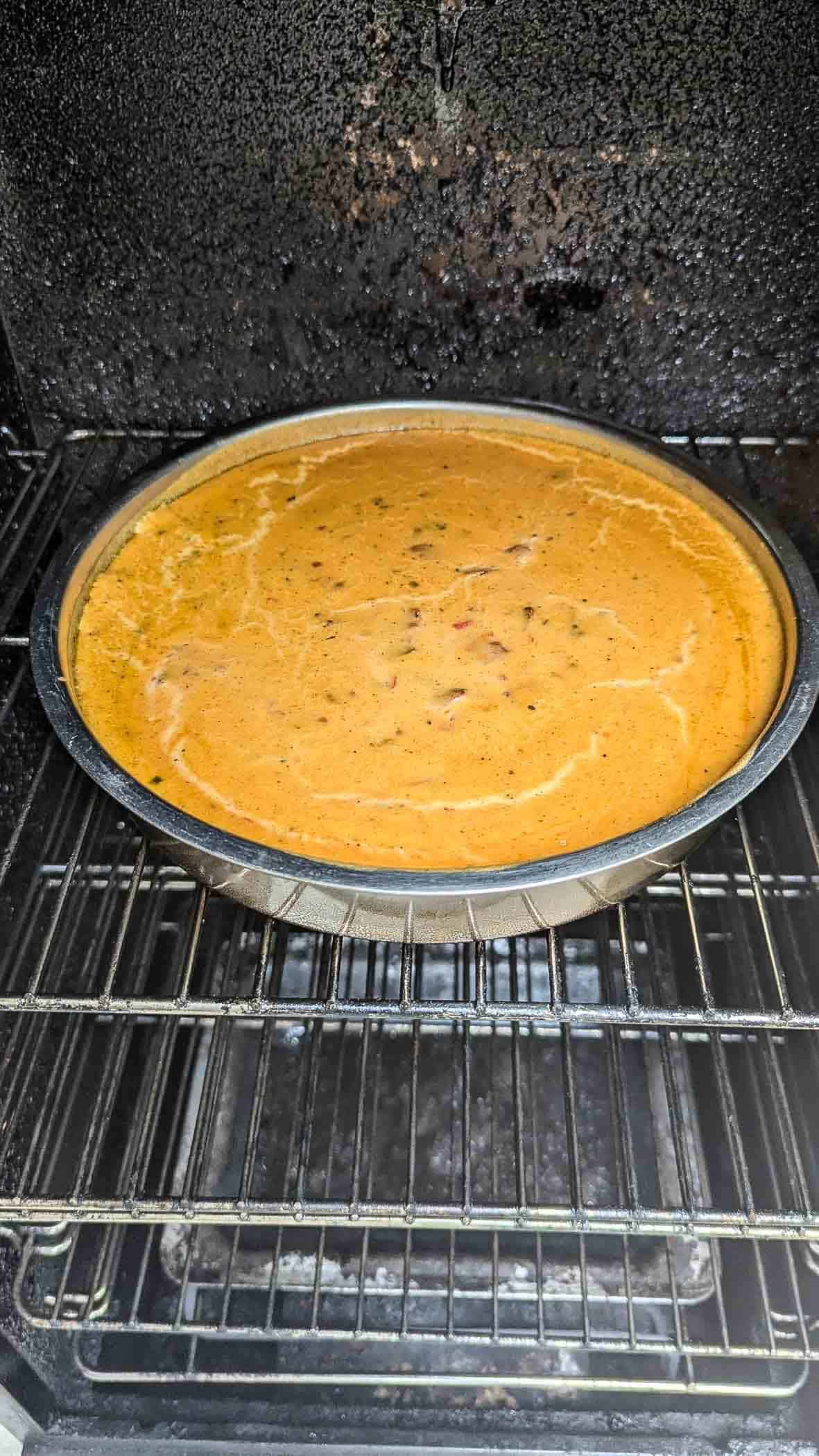 smoked queso dip (after 2 hours of smoking) in smoker.