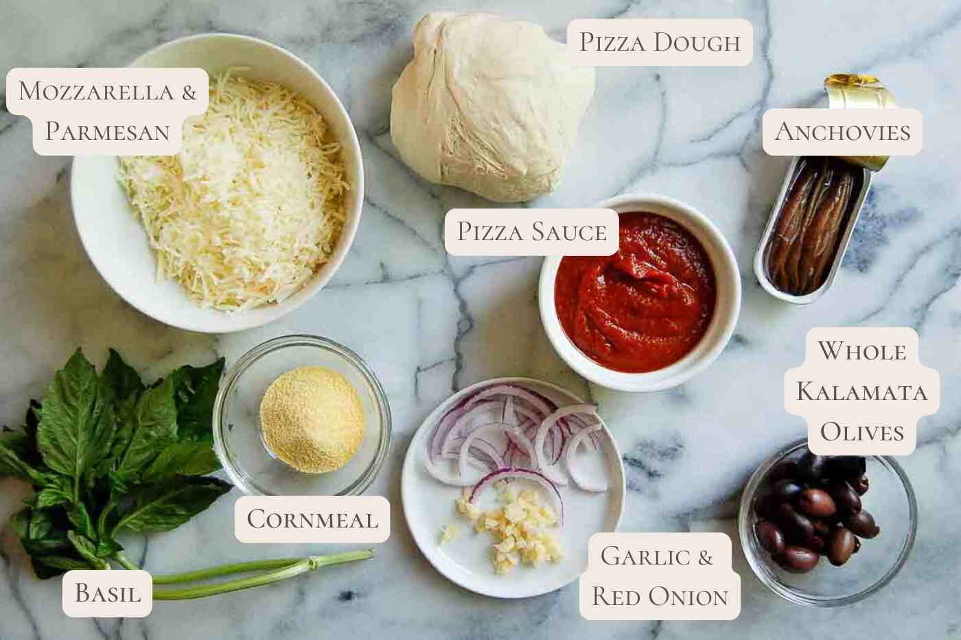 ingredients for anchovy pizza on countertop, labeled.