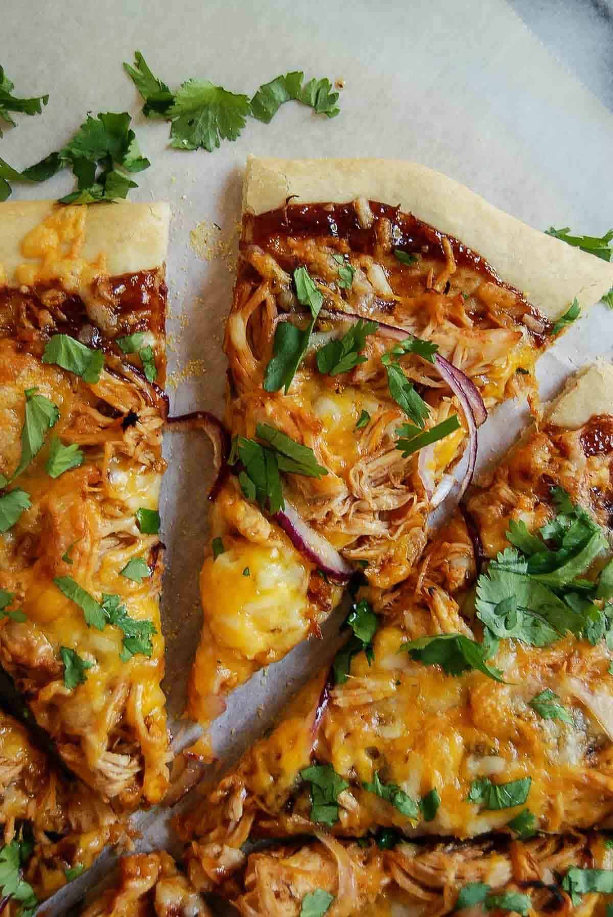 closeup of one slice of bbq chicken flatbread pizza.
