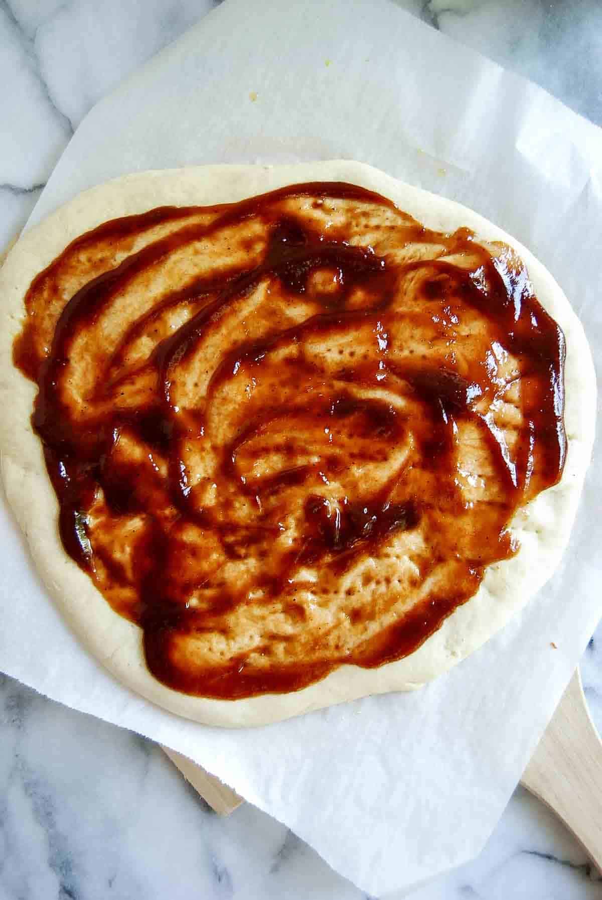 flatbread with bbq sauce spread across the top.