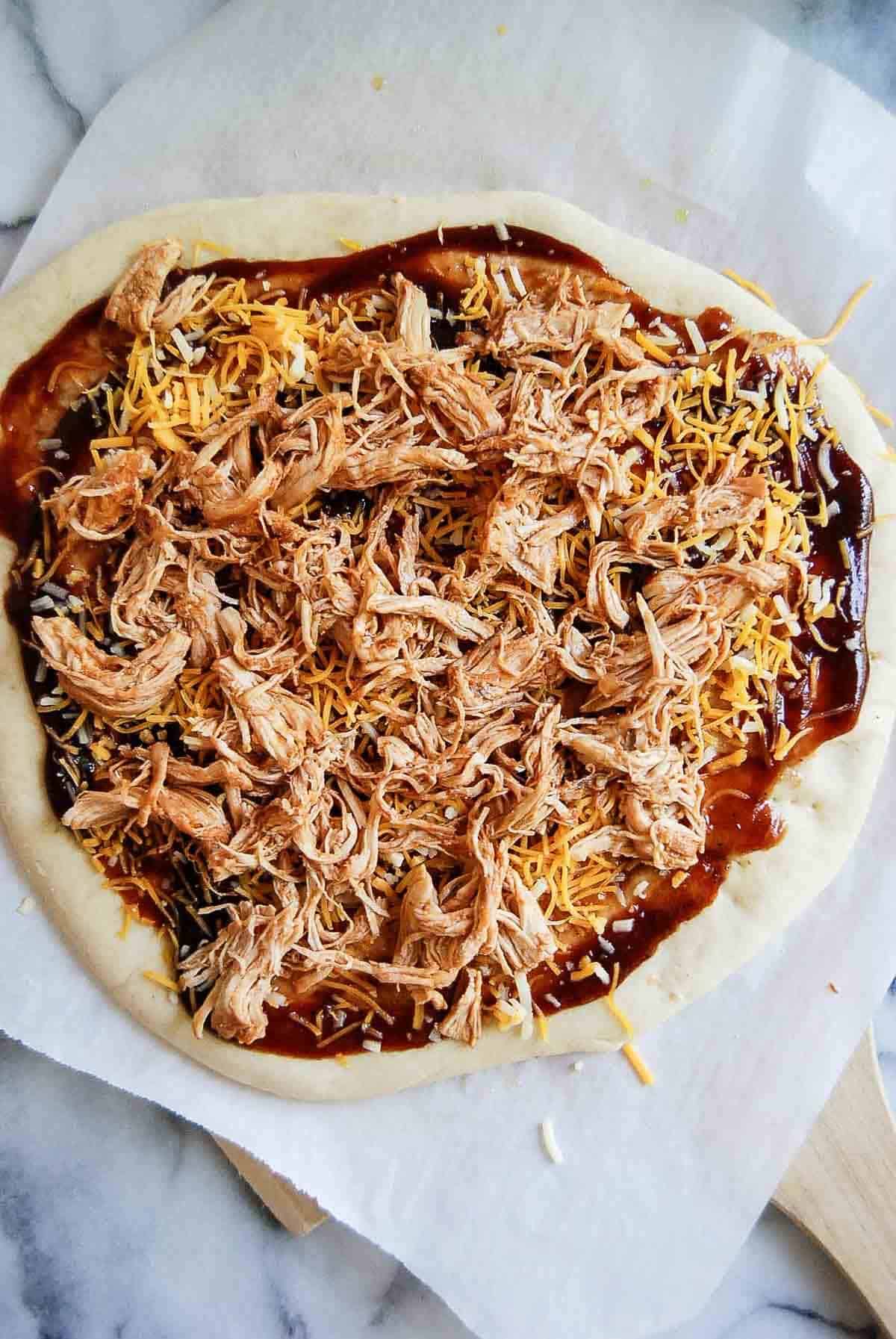 flatbread dough with bbq sauce, cheese and bbq chicken.