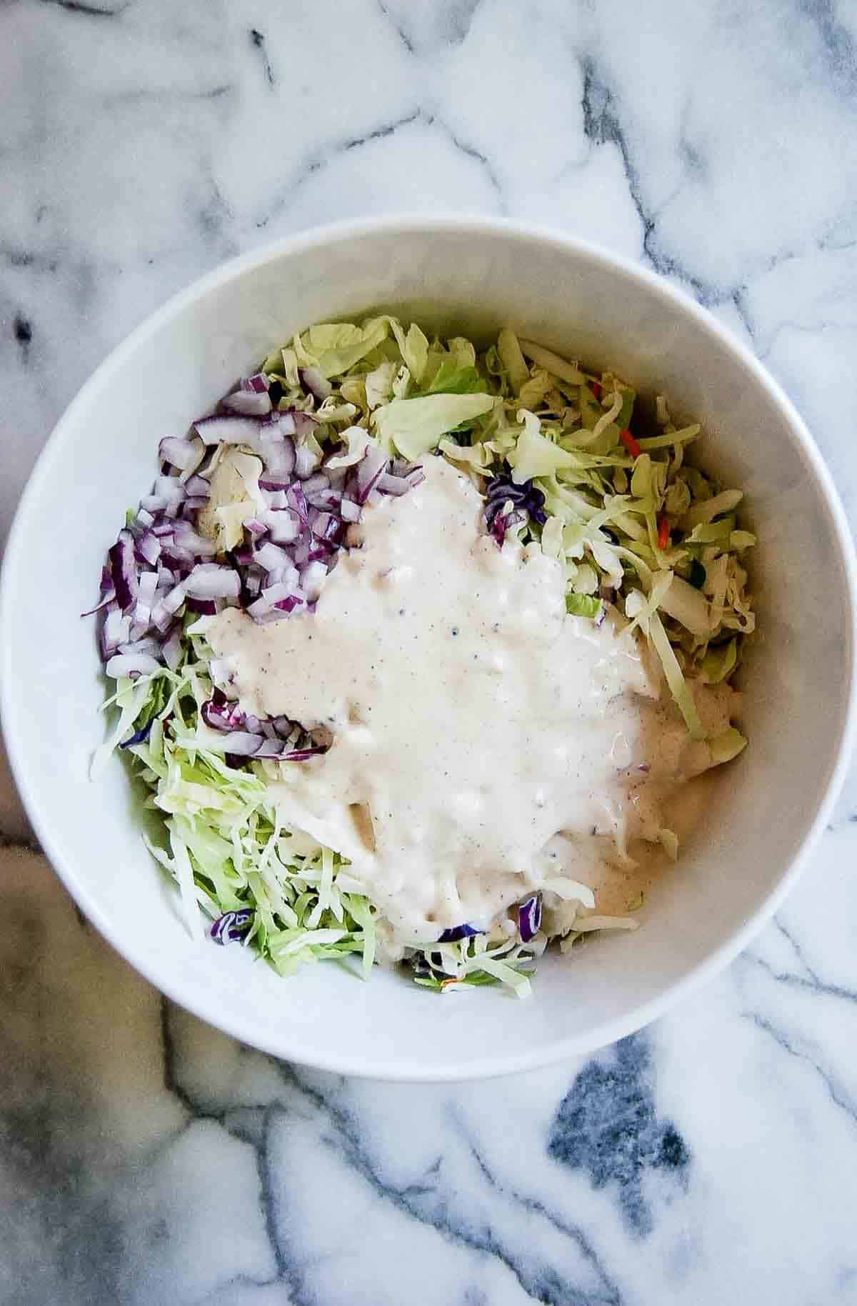 coleslaw mix with dressing poured over.