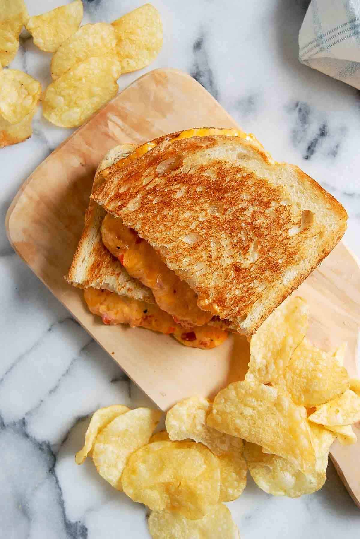 top down view of grilled pimento cheese sandwich on cutting board.