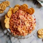 old fashioned pimento cheese dip in bowl with crackers on the side.