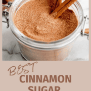 cinnamon sugar in bowl with cinnamon sticks on the side.