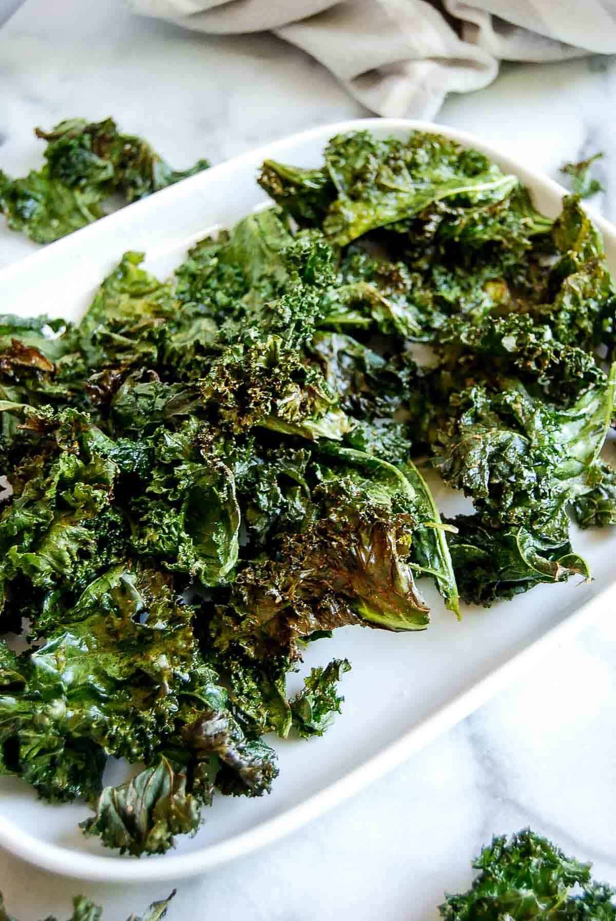 side view of air fryer kale chips.