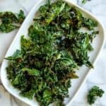 air fryer kale chip on platter on countertop.