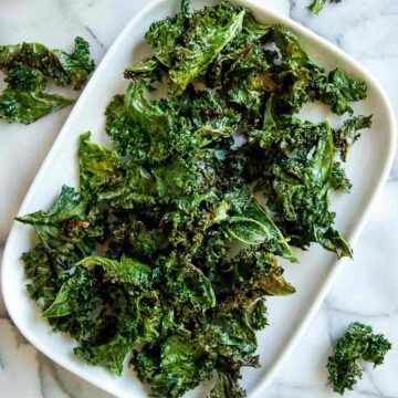 air fryer kale chip on platter on countertop.