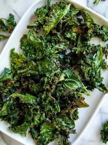 air fryer kale chip on platter on countertop.