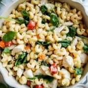 pot of Boursin cheese pasta with chicken and tomatoes on countertop.