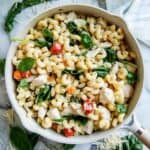 pot of Boursin cheese pasta with chicken and tomatoes on countertop.