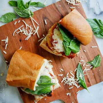 chicken parm sandwiches on cutting board.