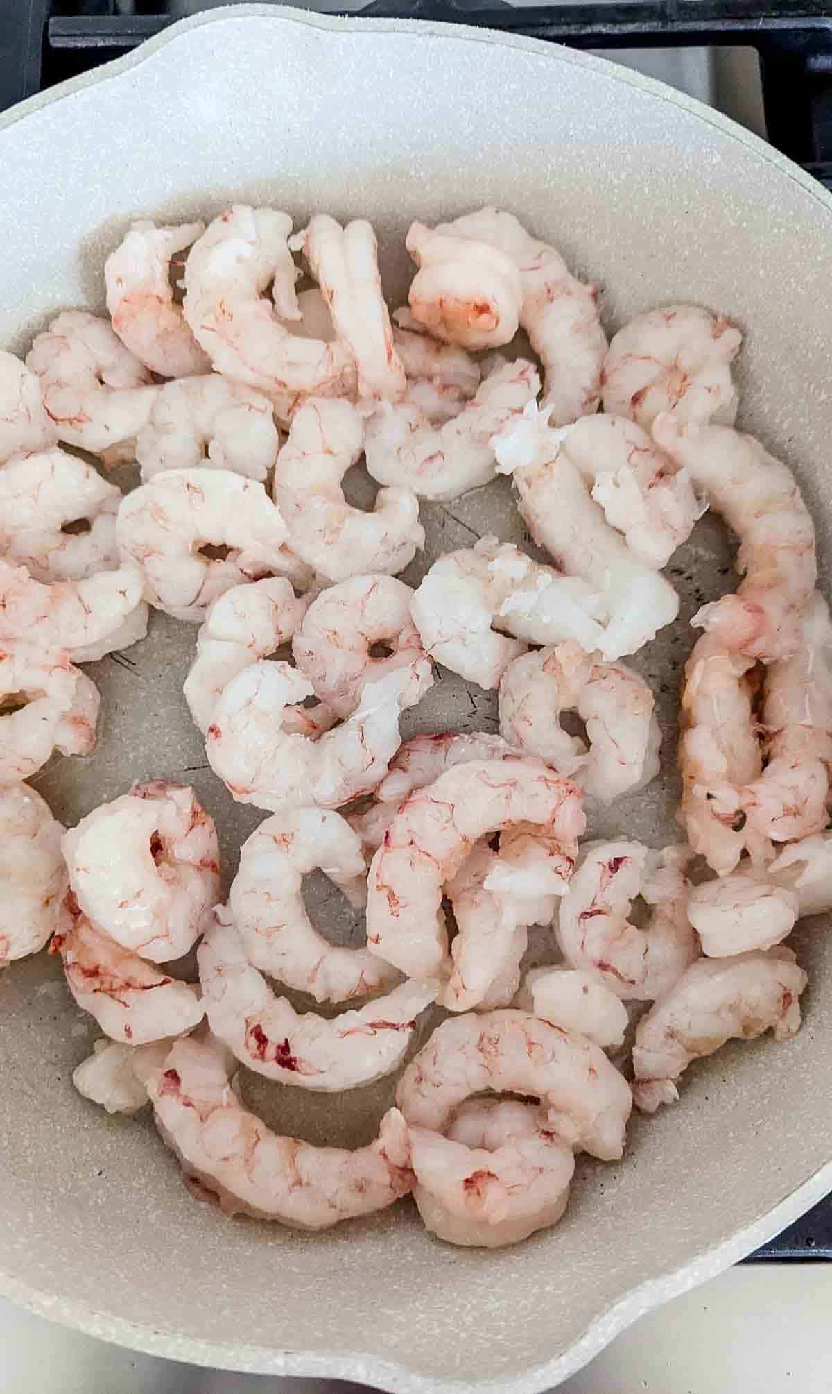 shrimp sautéing in pan.