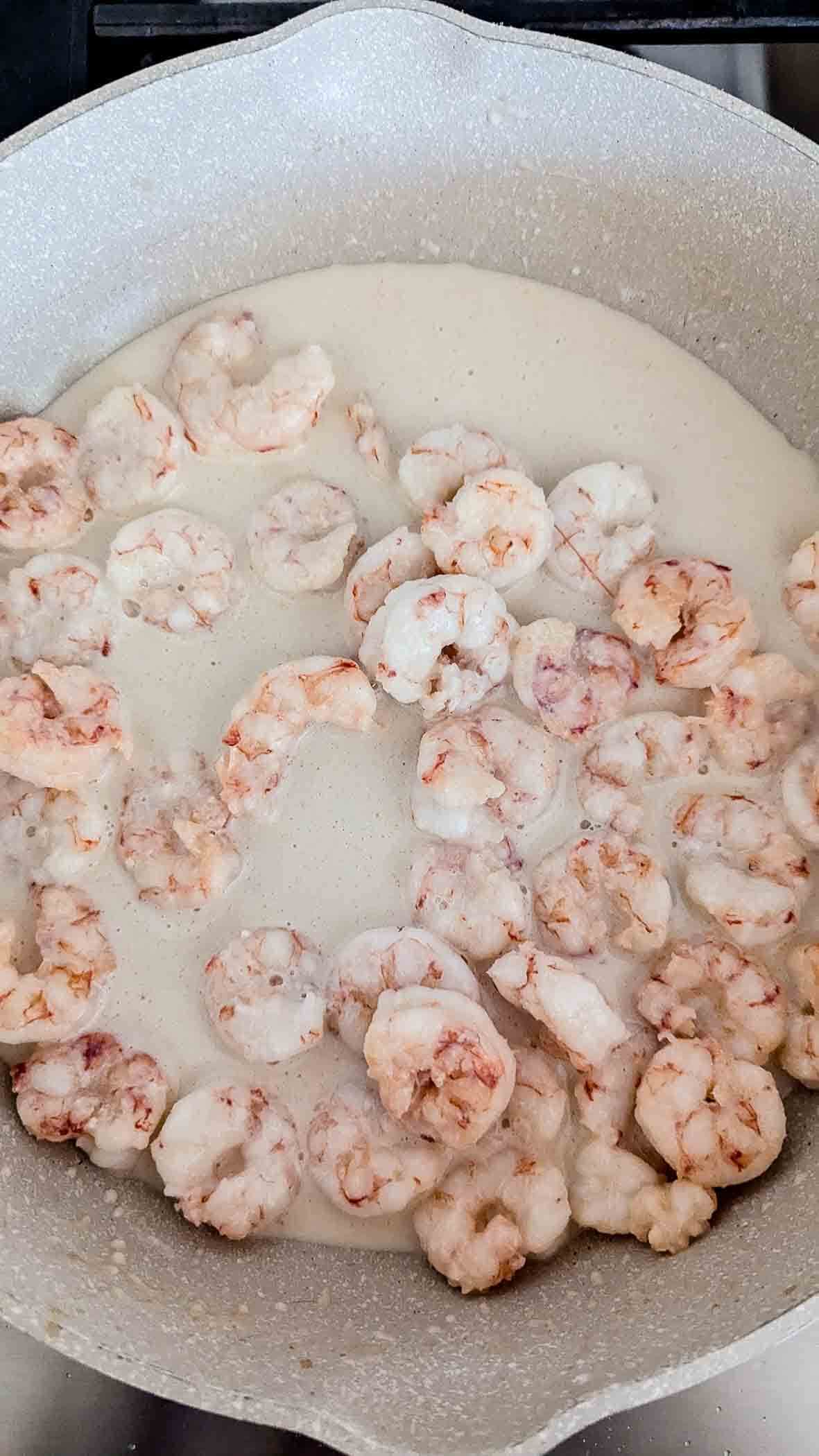 shrimp cooking in creamy coconut sauce.