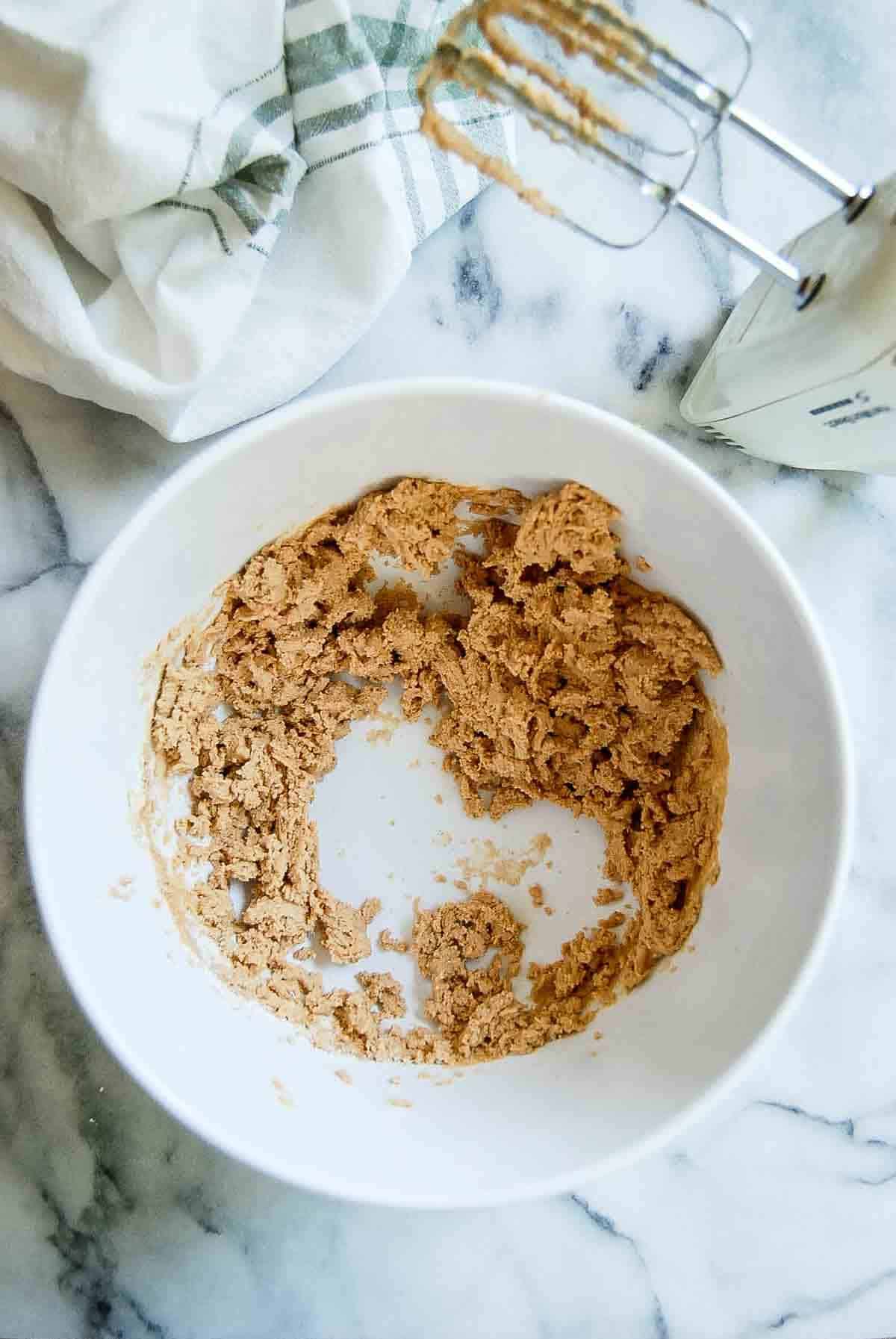 peanut butter filling in bowl with mixer on the side.