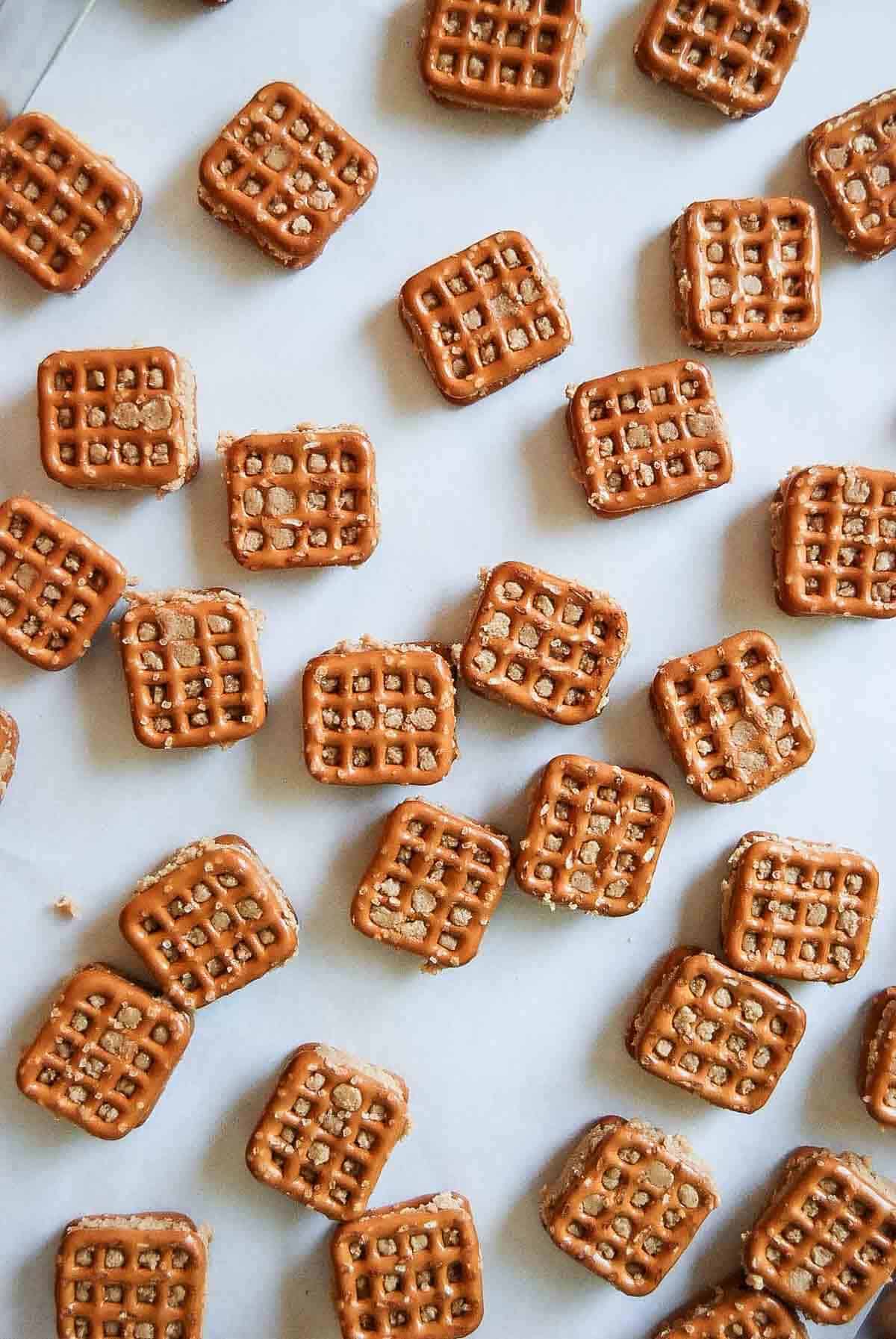 peanut butter pretzel sandwiches on baking tray.