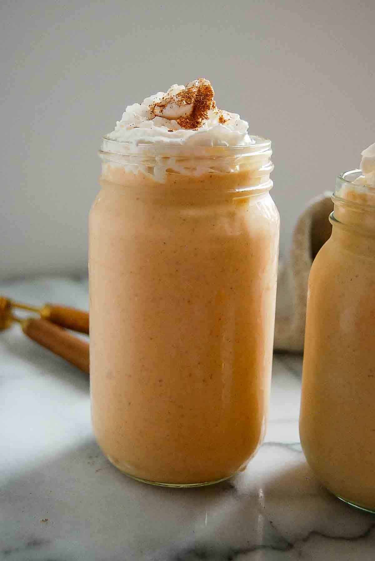 side view of pumpkin spice frosty with whipped cream.