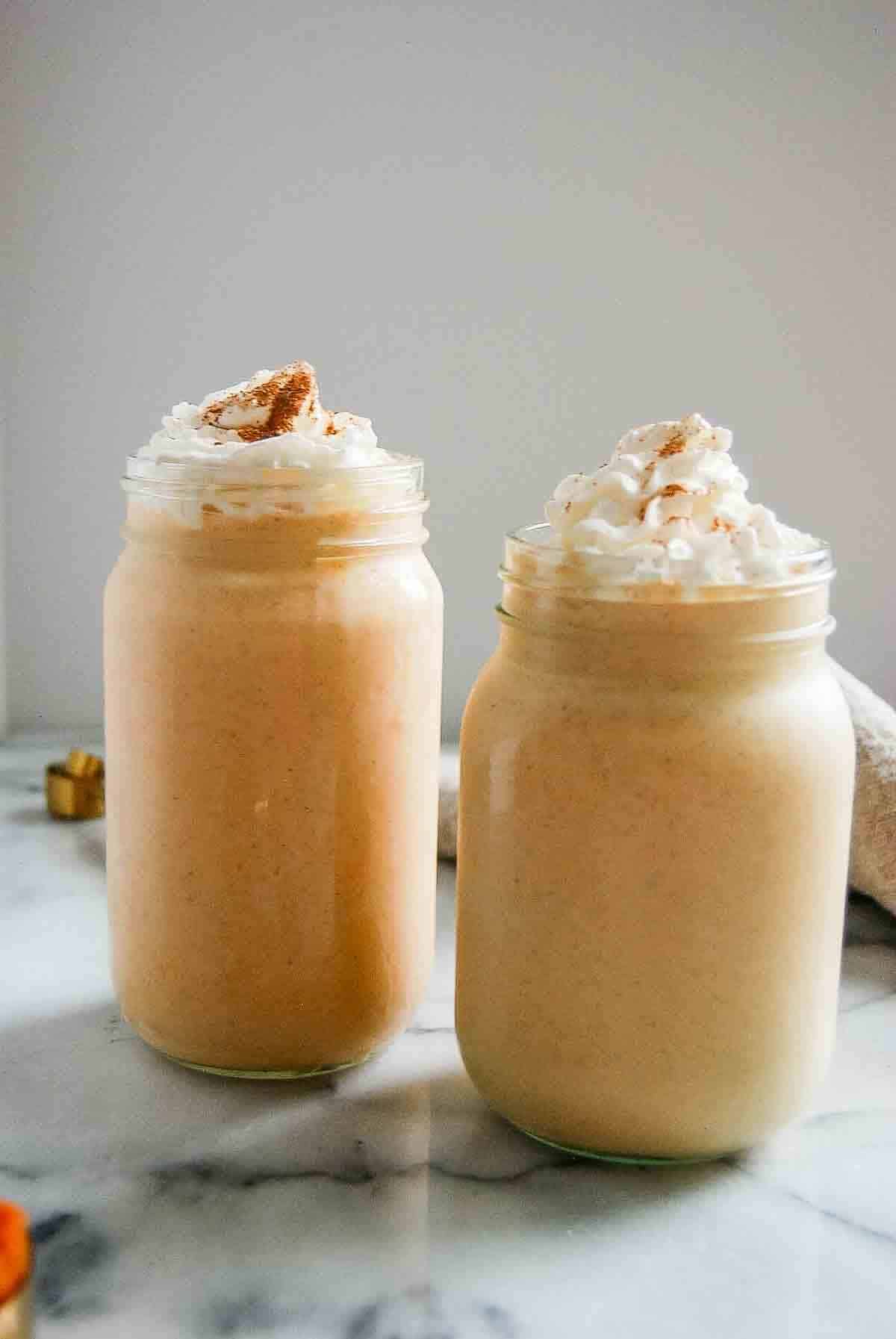 side view of pumpkin spice frosty with whipped cream.